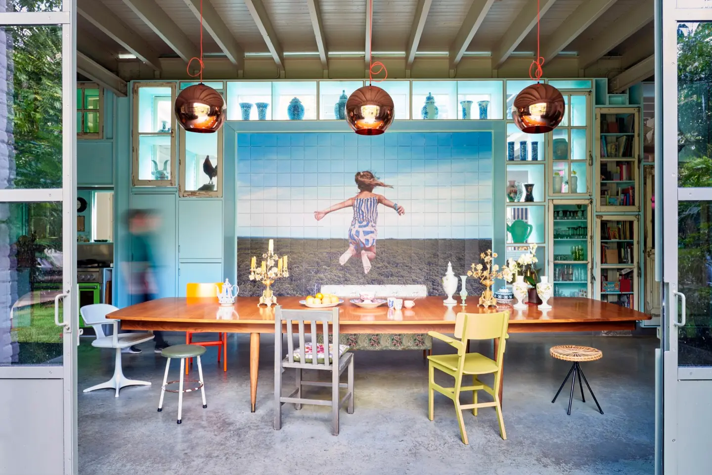 Photo wall of a jumping child filling the back wall of a garden kitchen
