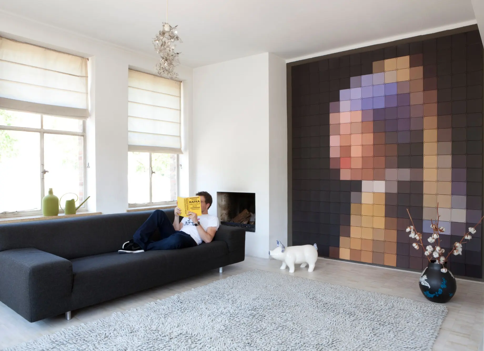 Pixel portrait covering a living room wall, from floor to ceiling