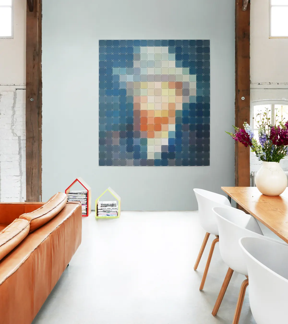 Een gepixeld zelfportret van Van Gogh vult de wand boven een bank