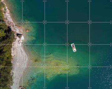 'Aerial View Of Emerald Lake And Boat' by Claire Droppert
