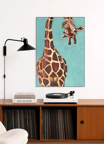 Giraffe with green leaf