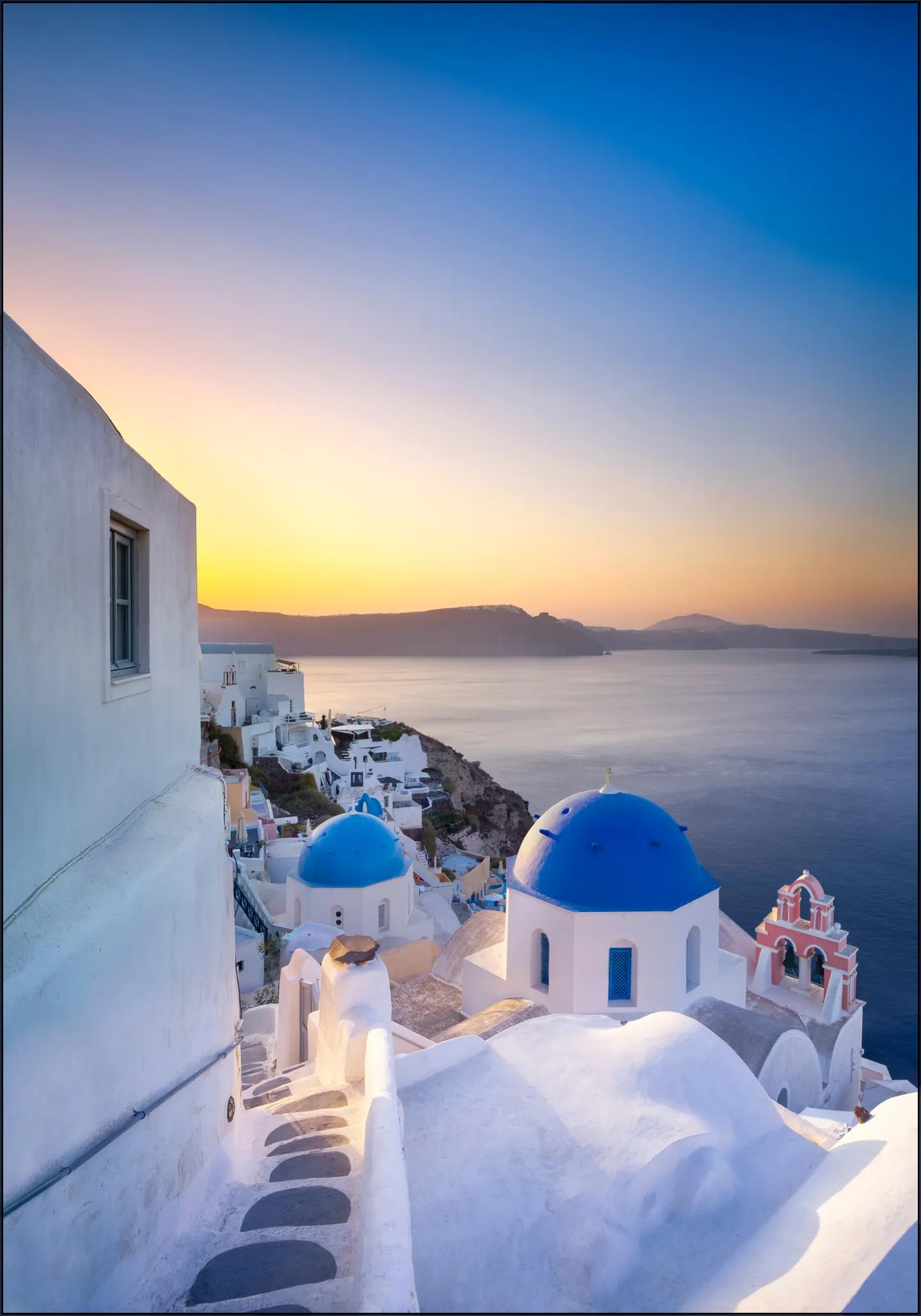 Sunrise over the blue rooftops in Oia, Santorini, Greece
