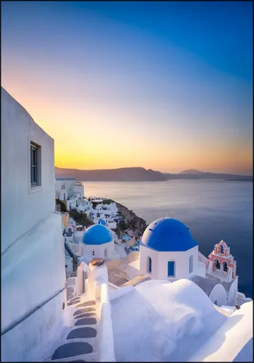 Sunrise over the blue rooftops in Oia, Santorini, Greece