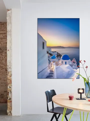Sunrise over the blue rooftops in Oia, Santorini, Greece