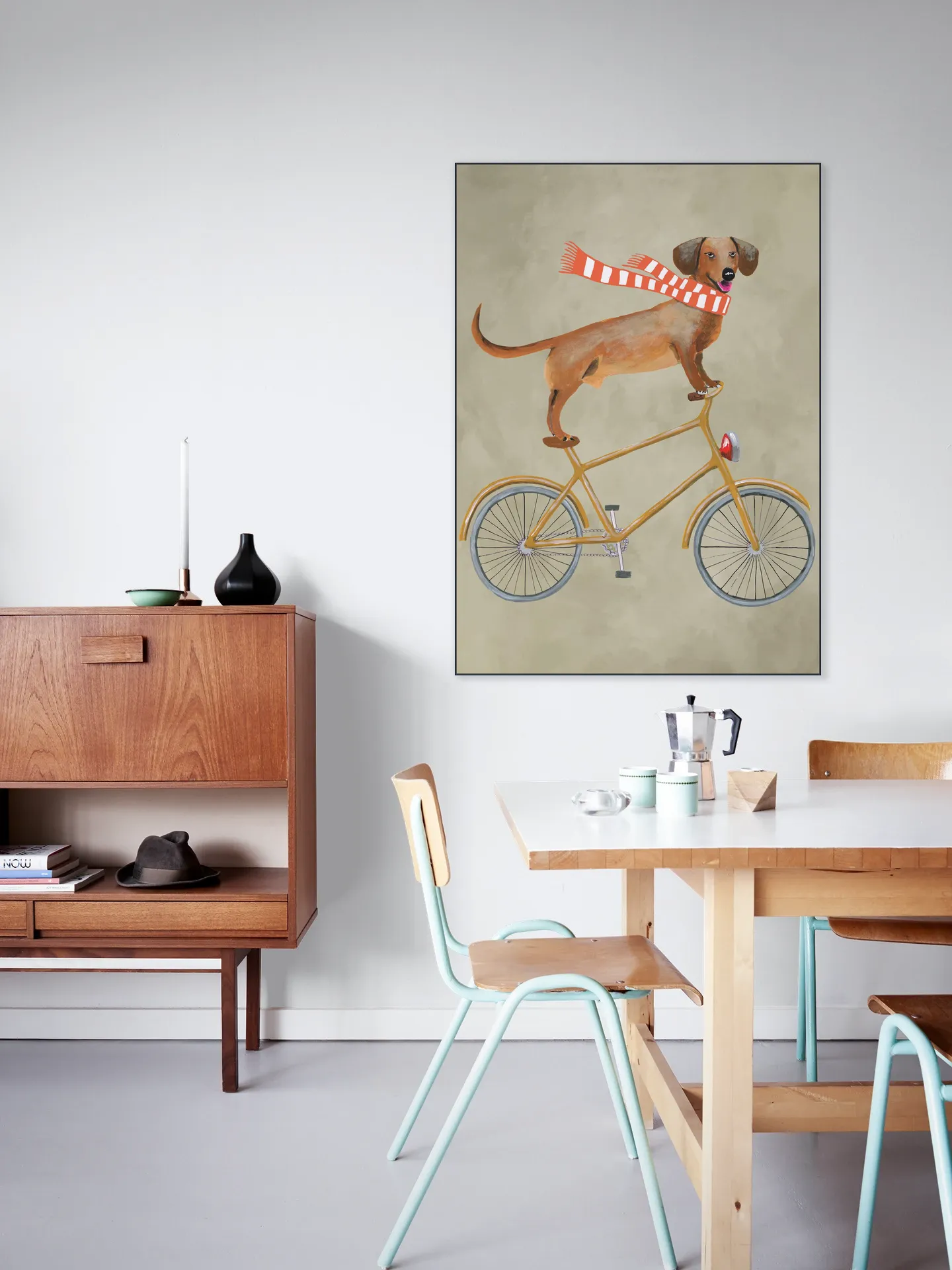 Dachshund on bicycle with scarf