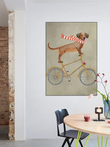 Dachshund on bicycle with scarf