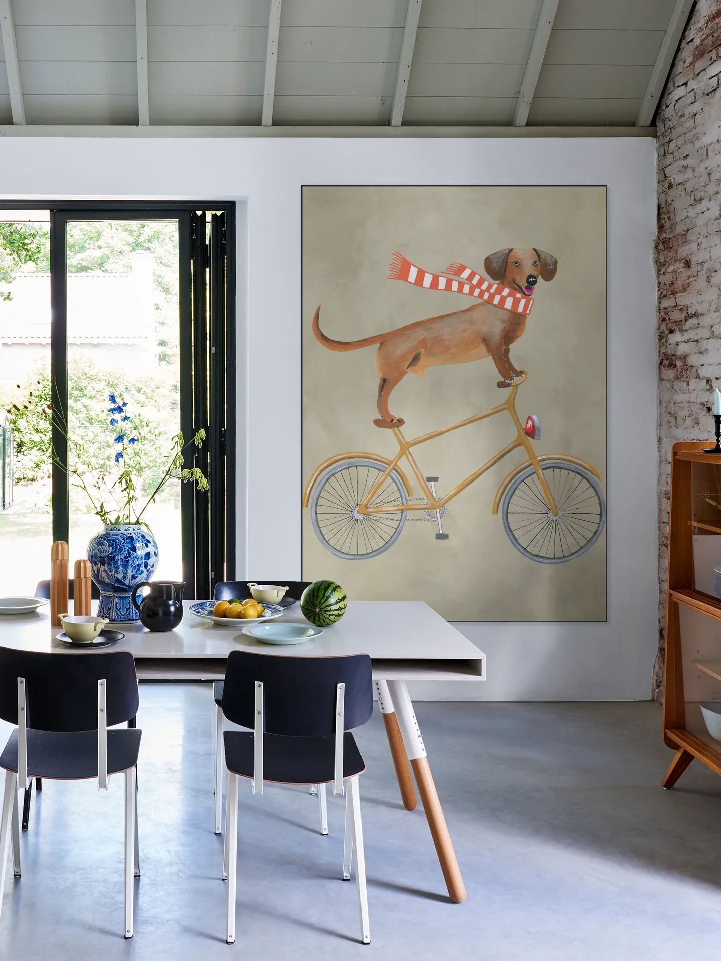 Dachshund on bicycle with scarf