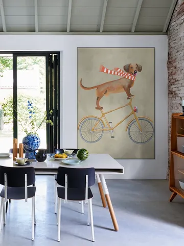 Dachshund on bicycle with scarf